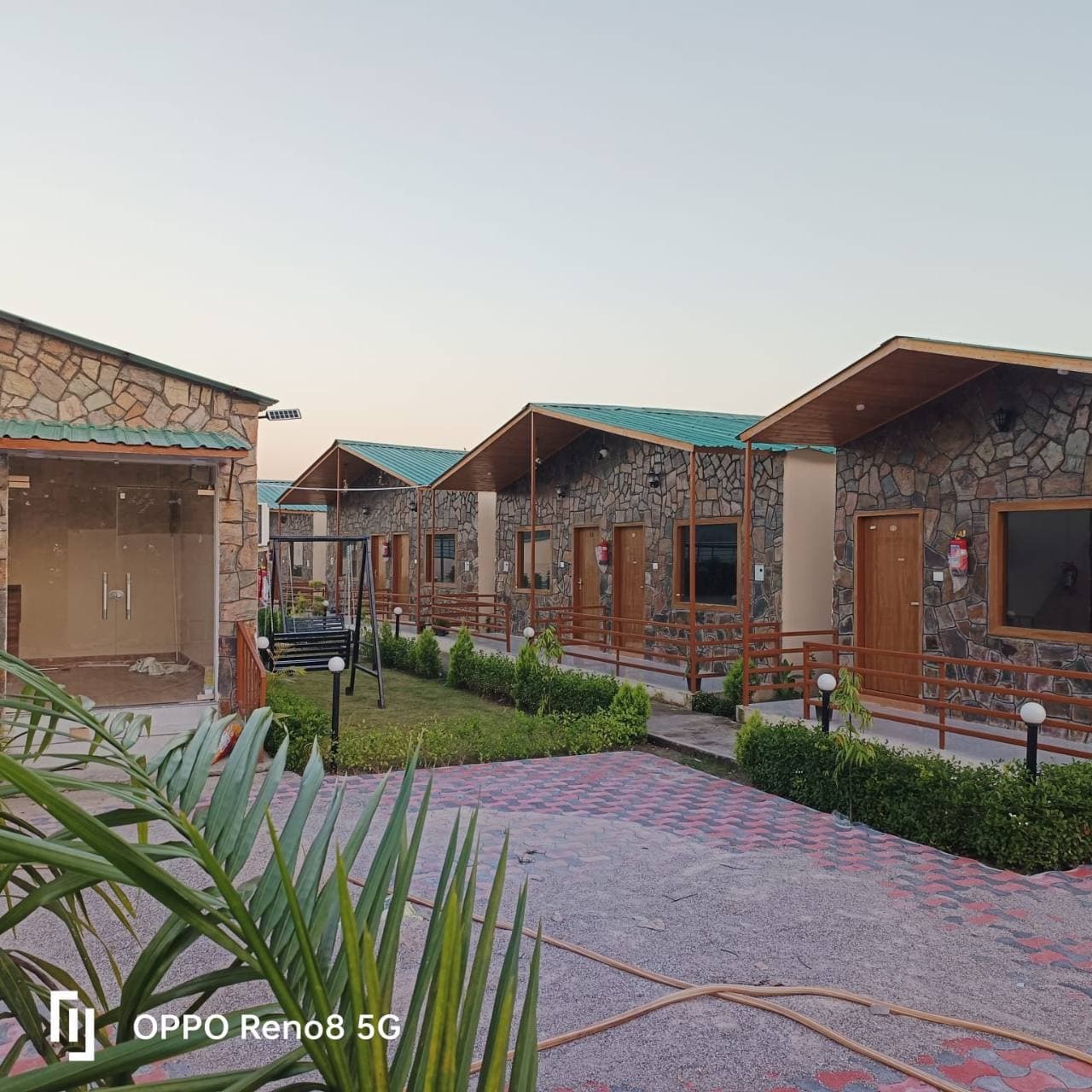 Furnished cottages with stone facades and a landscaped courtyard.