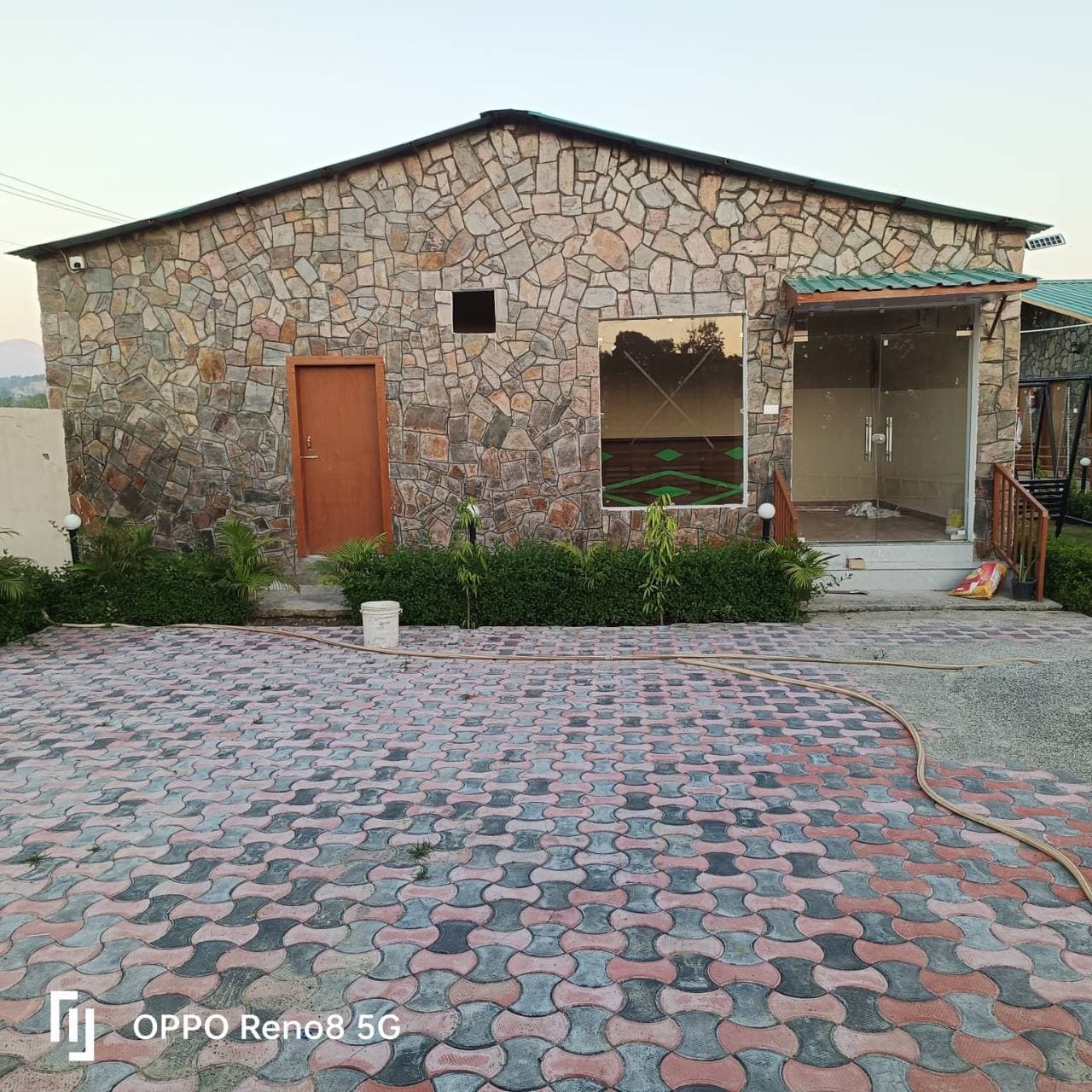 The front of a furnished cottage opening onto the courtyard.